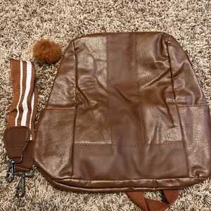 Brown Faux Leather Backpack purse with attachable strap and fuzzy ball- NWT